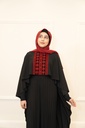This black jumpsuit features wide pleated legs and is handmade in Palestine
