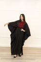 This black jumpsuit features wide pleated legs and is handmade in Palestine