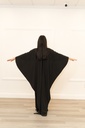 This black jumpsuit features wide pleated legs and is handmade in Palestine