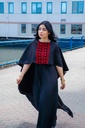 This black jumpsuit features wide pleated legs and is handmade in Palestine