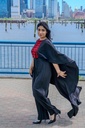 This black jumpsuit features wide pleated legs and is handmade in Palestine