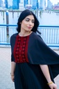This black jumpsuit features wide pleated legs and is handmade in Palestine
